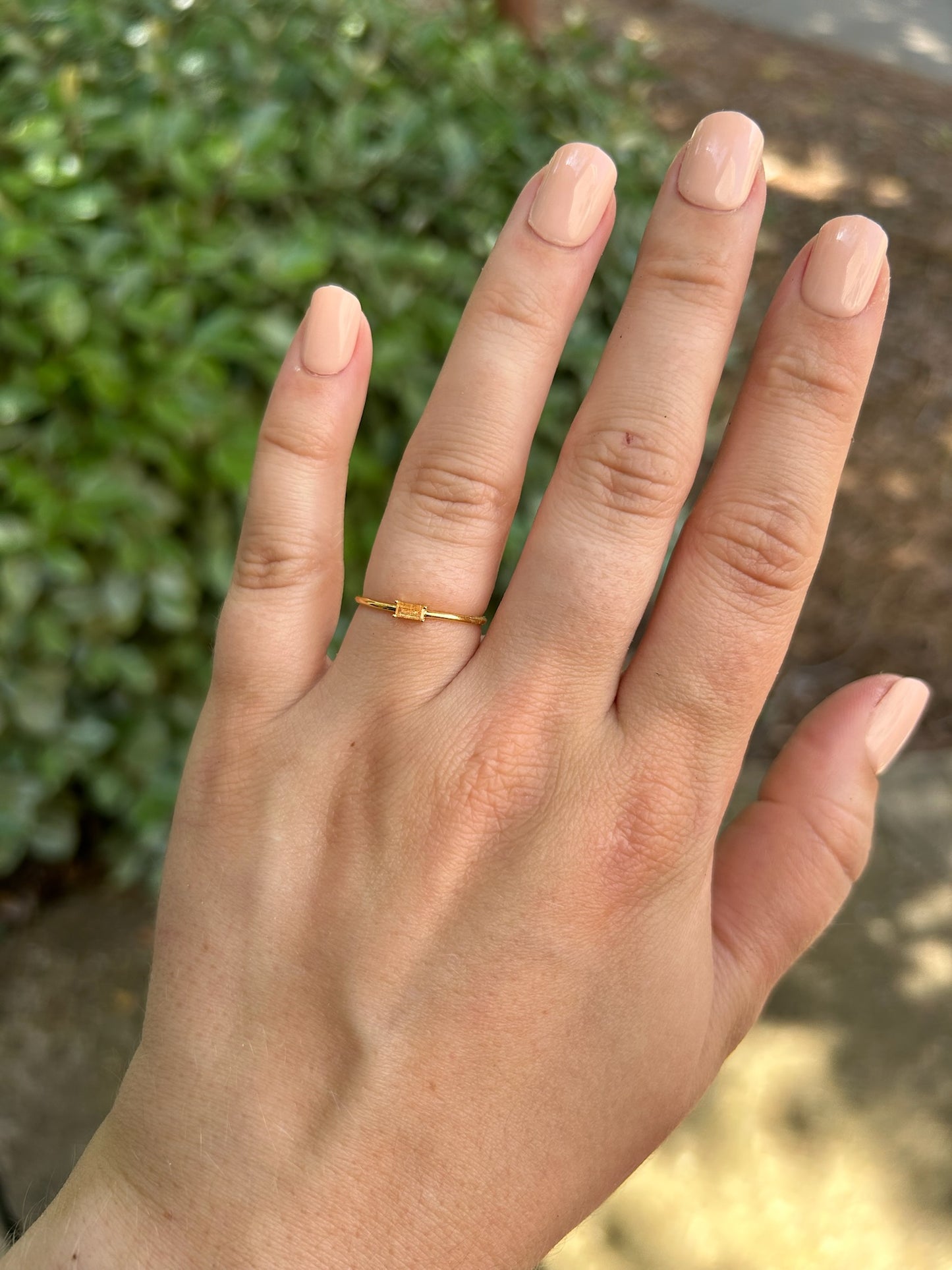 A close-up of a Canyon Jewelry Borgia Ring with a rectangular diamond, set on a mossy surface, with a blurred background emphasizing the ring’s detail as statement jewelry.